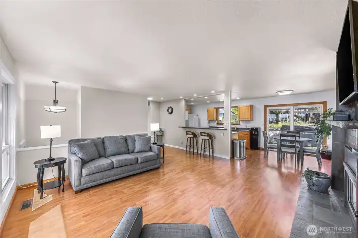 Living room flows to dining area and eating with additional space for entertaining with eating bar.