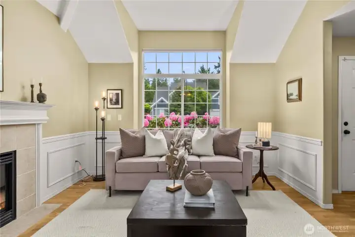 The living room also features a large picture window that fills the space with abundant natural light.