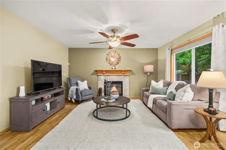 Perfect-sized family room featuring an additional gas fireplace with a stylish tile surround.
