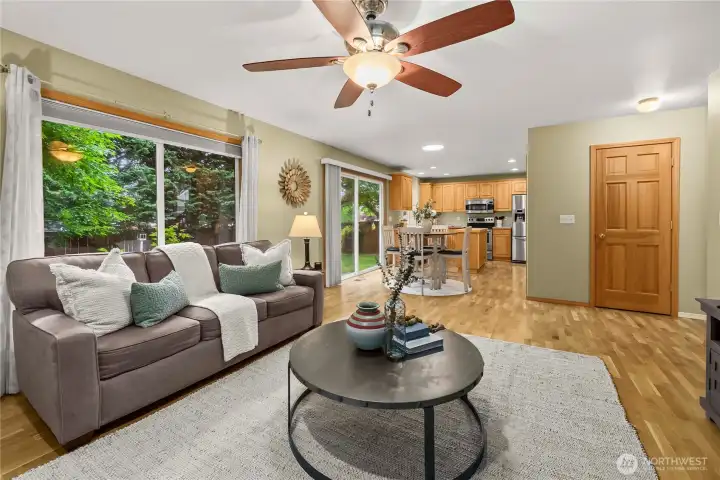 View from the family room looking back toward the eat-in kitchen area, highlighting the open and connected layout.