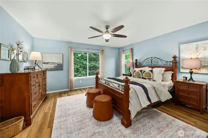 Spacious primary upstairs bedroom featuring abundant natural light and a ceiling fan for year-round comfort.