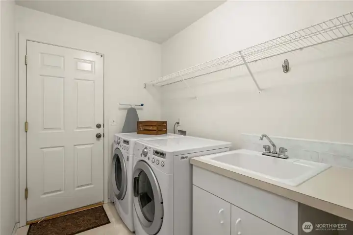 Downstairs laundry with easy access from the garage—perfect as a functional mudroom setup.