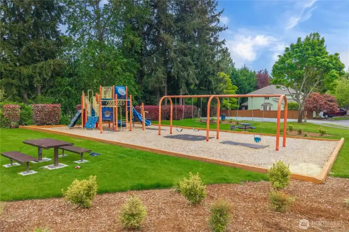 Nearby playground featuring a picnic area, swings, and a play structure for outdoor fun and recreation.