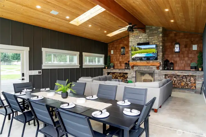 Outdoor living space with dining area, seating area to watch the game, wood burning fireplace to set the mood...also has beverage refrigerator, ice machine and grill. Outdoor living space with dining area, seating area to watch the game, wood burning fireplace to set the mood...also has beverage refrigerator, ice machine and grill.