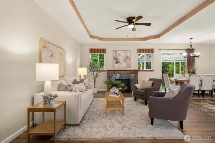 The open concept floor plan offers generous spaces to relax or gather. Cozy gas fireplace, coved ceiling detail and newer LVP flooring.