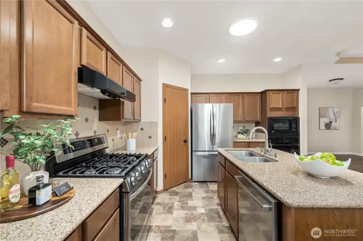 Classic kitchen boasts of Quartz counters, full heigh backsplash, warm wood cabinets and newer appliances.