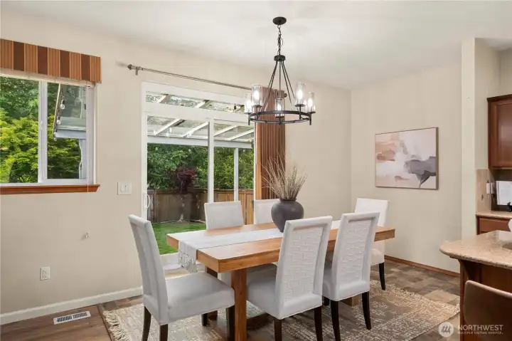 The spacious dining area overlooks the lush and private backyard.