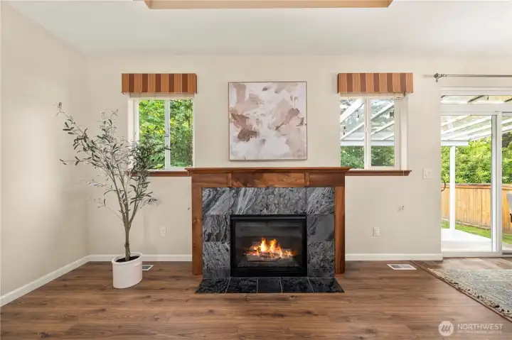 Cozy gas fireplace with striking wood mantle.