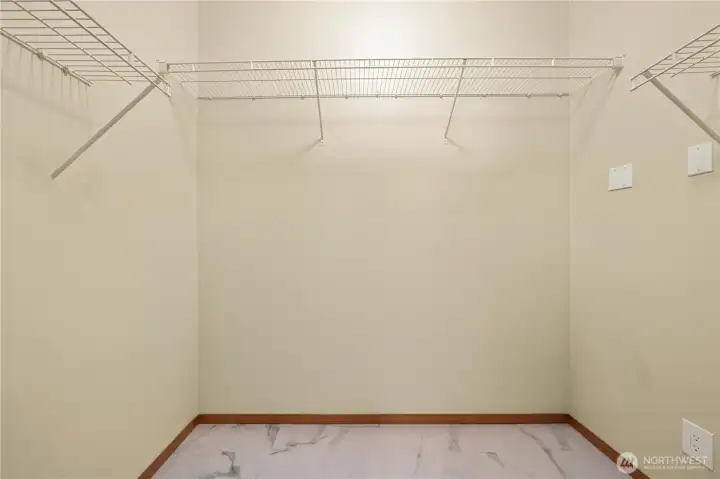 Generous walk-in closet in the primary with newer hard surface flooring.