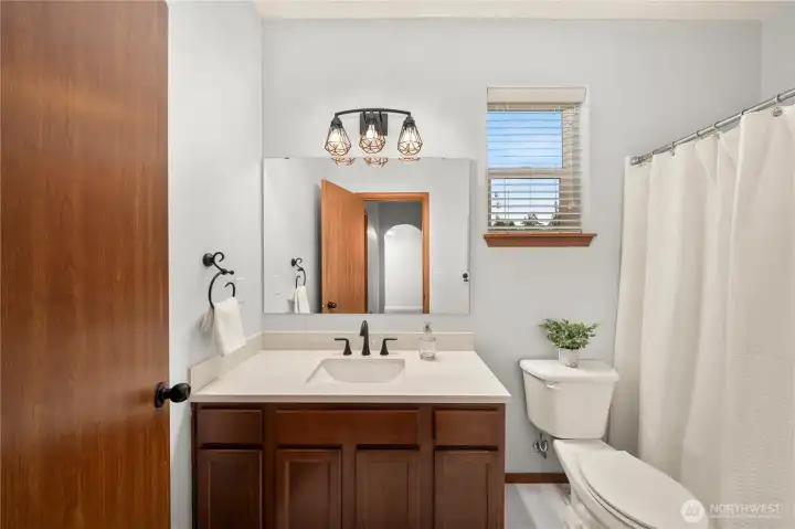 Newly updated 2nd bathroom including beautiful sintered stone countertop and designer lighting.