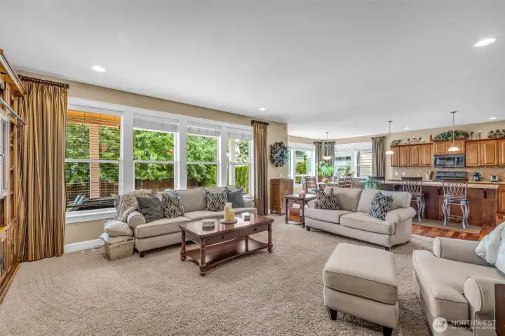 Light-filled family room with oversized windows, plush carpeting, and an open layout that makes the home feel warm, comfortable, and welcoming. Light-filled family room with oversized windows, plush carpeting, and an open layout that makes the home feel warm, comfortable, and welcoming.