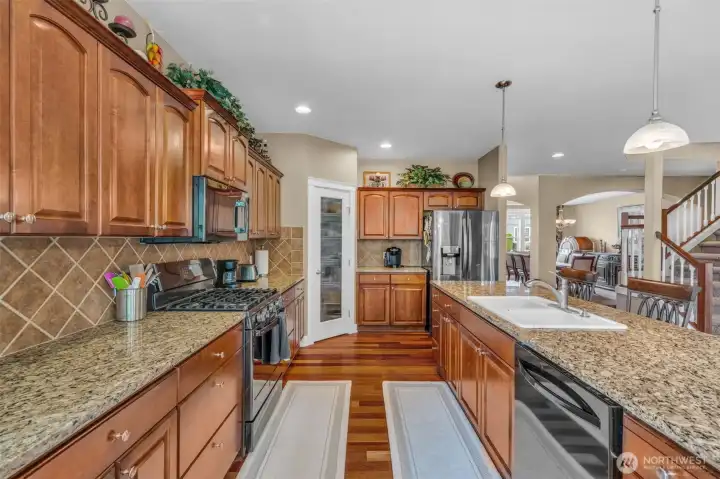 Beautifully appointed kitchen with stainless steel appliances, granite countertops, tile backsplash, and ample workspace for meal preparation. Beautifully appointed kitchen with stainless steel appliances, granite countertops, tile backsplash, and ample workspace for meal preparation.