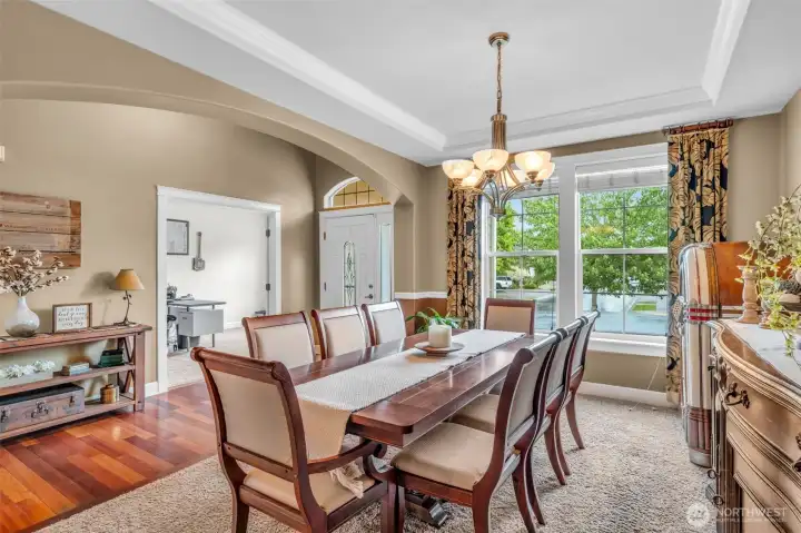 Elegant formal dining room with crown molding, large picture windows, and ample space for hosting holiday gatherings and special occasions. Elegant formal dining room with crown molding, large picture windows, and ample space for hosting holiday gatherings and special occasions.