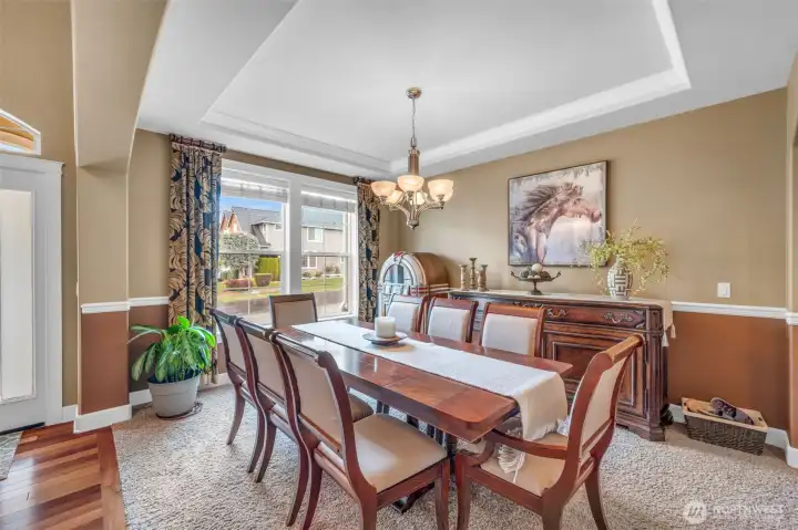 The formal dining room offers an inviting space for entertaining, highlighted by crown molding and large windows. The formal dining room offers an inviting space for entertaining, highlighted by crown molding and large windows.
