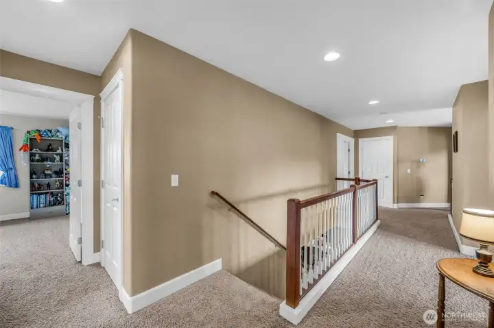Spacious upstairs landing with open railing detail, recessed lighting, and easy access to the bedrooms, bonus room, and laundry area, creating an open and connected feel throughout the upper level. Spacious upstairs landing with open railing detail, recessed lighting, and easy access to the bedrooms, bonus room, and laundry area, creating an open and connected feel throughout the upper level.