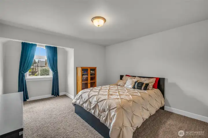 Comfortable bedroom with abundant natural light and a charming window nook. Comfortable bedroom with abundant natural light and a charming window nook.