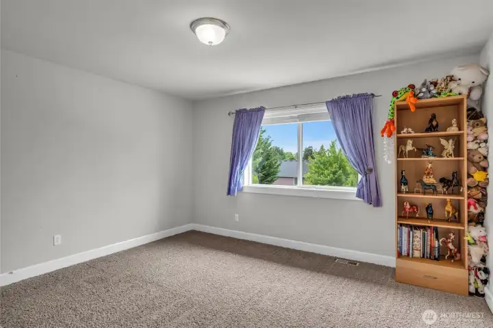 Bright and spacious bedroom featuring plush carpeting, large windows, and ample space for furniture and personal touches. Bright and spacious bedroom featuring plush carpeting, large windows, and ample space for furniture and personal touches.