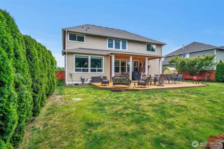 Spacious fully fenced backyard featuring a large patio, mature landscaping, and plenty of room for gatherings, play, or relaxation. Spacious fully fenced backyard featuring a large patio, mature landscaping, and plenty of room for gatherings, play, or relaxation.