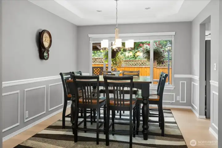 Formal dining room with coffered ceiling with chair rail molding.