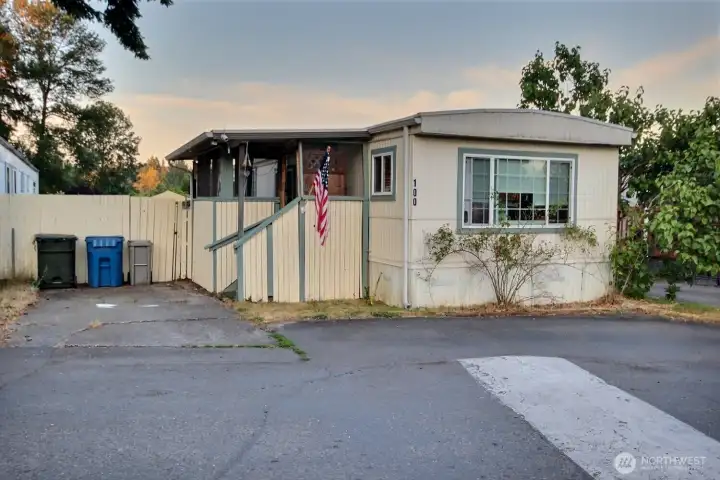 Exterior view of manufactured home with assigned parking and entry access in Cascade Mobile Villa. Exterior view of manufactured home with assigned parking and entry access in Cascade Mobile Villa.
