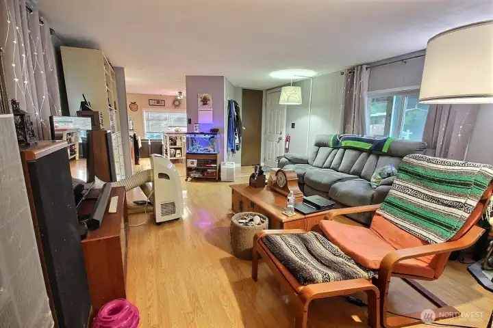 Living room with natural light, laminate flooring, and functional everyday layout. Living room with natural light, laminate flooring, and functional everyday layout.