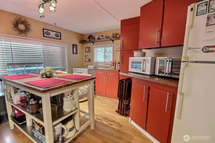 Kitchen and dining area with center island, storage, and included appliances. Kitchen and dining area with center island, storage, and included appliances.