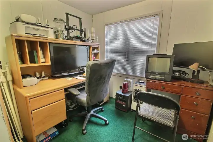 Flexible bedroom or office space with desk setup, window light, and functional work-from-home potential. Flexible bedroom or office space with desk setup, window light, and functional work-from-home potential.