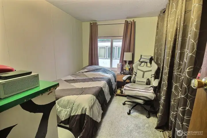Bedroom with closet storage, natural light, and comfortable personal living space. Bedroom with closet storage, natural light, and comfortable personal living space.