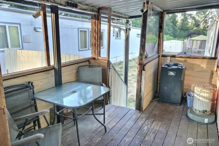 Covered porch/sunroom area for sheltered outdoor seating. Covered porch/sunroom area for sheltered outdoor seating.
