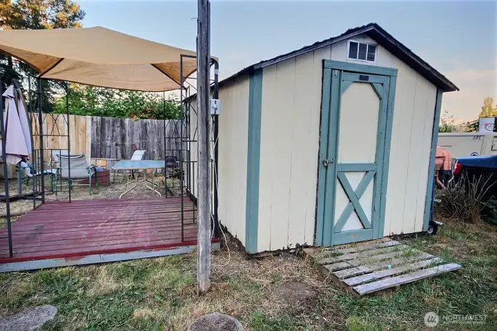 Shed and covered outdoor area supporting extra storage and utility. Shed and covered outdoor area supporting extra storage and utility.