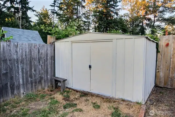 Exterior storage shed offering additional space for tools or seasonal items. Exterior storage shed offering additional space for tools or seasonal items.