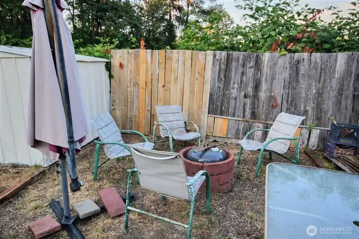 Outdoor firepit seating area for casual gatherings and relaxation. Outdoor firepit seating area for casual gatherings and relaxation.