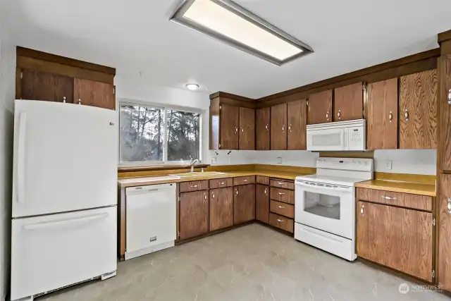 The kitchen sink looks out to the spacious fully fenced back yard.