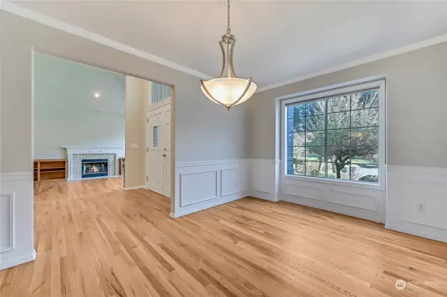 Across from the living room is the dining room that is accented by crown molding wainscotting.