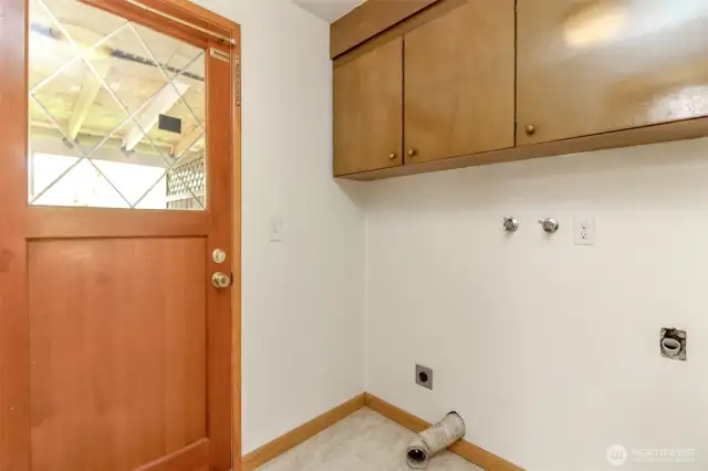 Laundry room with seperate entrance leading to patio area and another door to the garage.