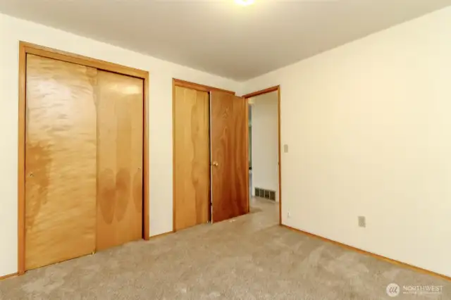 Primarily bedroom with two large closets.