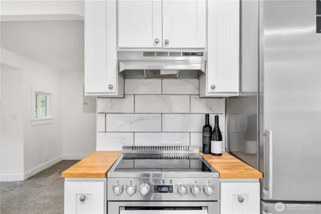 A touch of butcher block warmth frames the cooking space, blending efficiency and style in perfect balance. Ideal for any home chef or weekend cook who values both form and function.