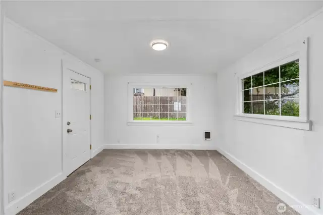 This inviting living space features fresh carpet, crisp white walls, and large windows that let in tons of natural light.