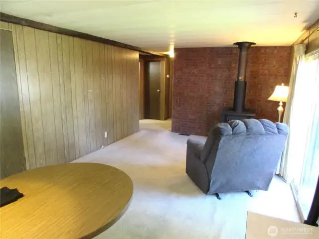 KITCHEN OPENS TO FAMILY ROOM, HALLWAY AND SLIDING GLASS DOOR TO RIGHT.