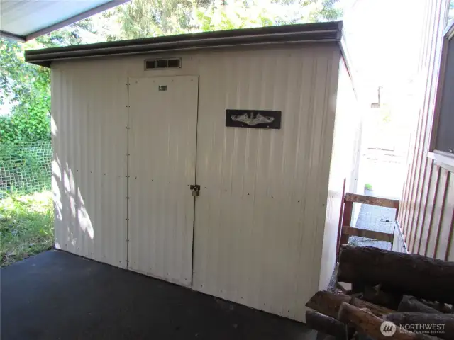 END OF CARPORT SHED W/ GATE TO BACK YARD TO RIGHT.