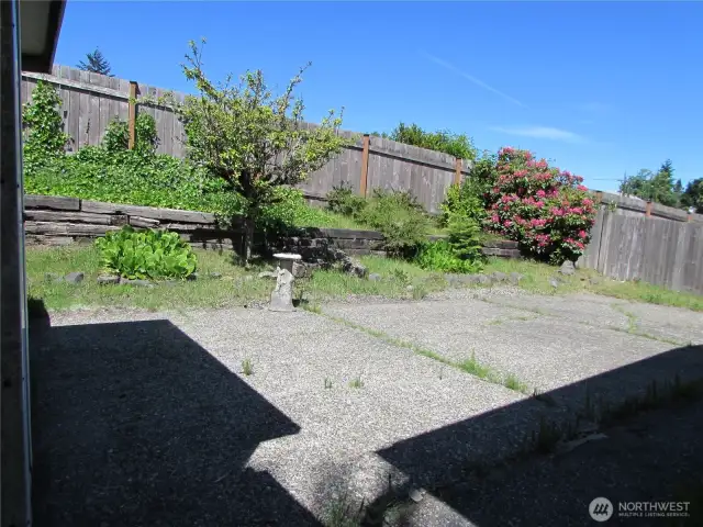 LARGE CEMENT PATIO, PRIVATE BACK YARD SETTING, BACK UP TO CHURCH PARKING LOT.