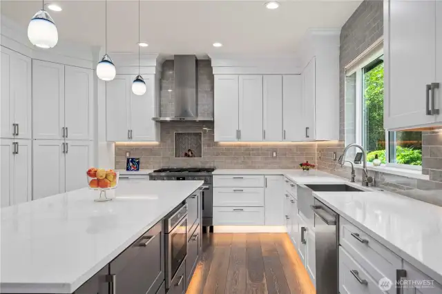 Quartz countertops, an undermount sink with a hot water dispenser, while a walk-in pantry ensures effortless organization.
