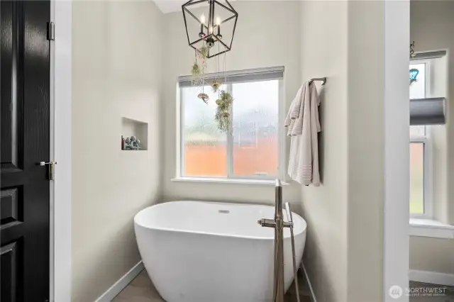 The ensuite is paired with a decadent soaking tub for ultimate relaxation.