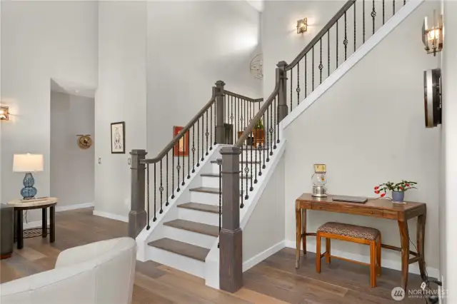 Ascend the grand staircase, where custom wood railings with iron balusters and hardwood steps showcase unparalleled craftsmanship.