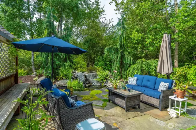 Outside, lush landscaping, nourished by an irrigation system, frames a tranquil koi pond.