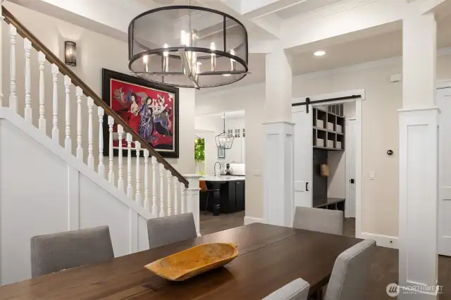 Serving up style: this chic dining room delivers standout lighting, architectural charm, and a sneak peek into the ultra-organized mudroom—because even your coats and shoes deserve a designer moment.