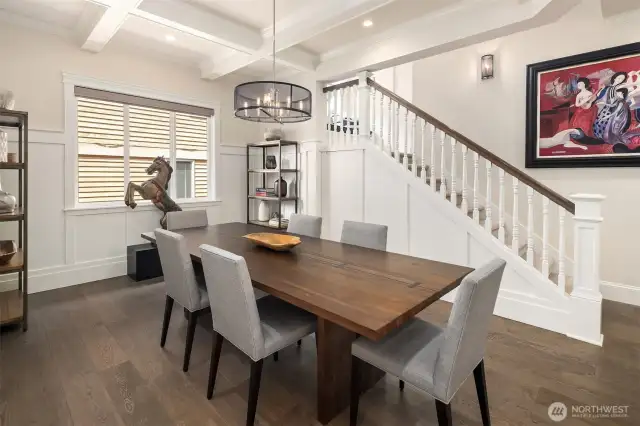 Dinner with a side of clever design—this elegant dining room stuns with coffered ceilings, statement lighting, and a hidden surprise: a discreet under-stair storage space that’s perfect for tucking away anything from table linens to your secret snack stash.