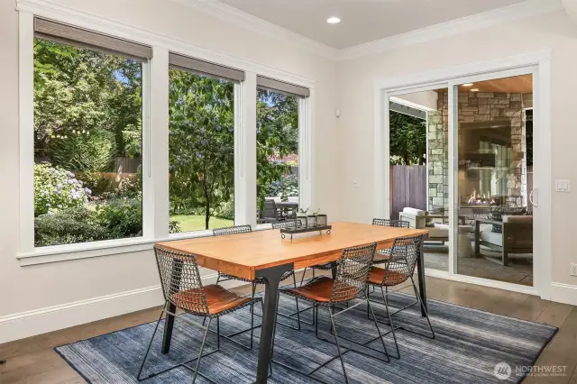Sun-drenched breakfast nook with garden views by day, cozy fireside dinners by night—this indoor-outdoor connection serves up ambiance on demand.