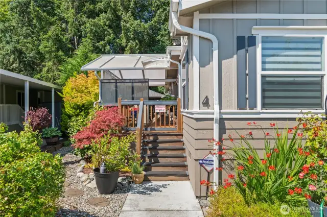 Lovingly landcaped and welcoming covered front porch area.