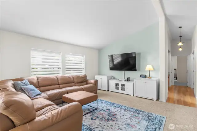 Spacious great room situated right off the dining area, view of hall leading down to bedrooms and den. The hall offers convenient built ins.